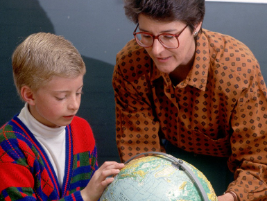 A Volunteer helps a child understand his world